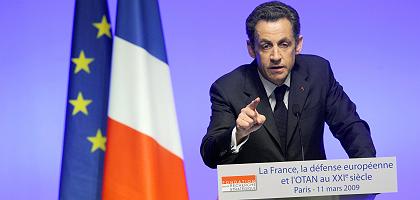 France's President Nicolas Sarkozy announces in Paris that France would rejoin NATO's integrated military command on March 11, 2009